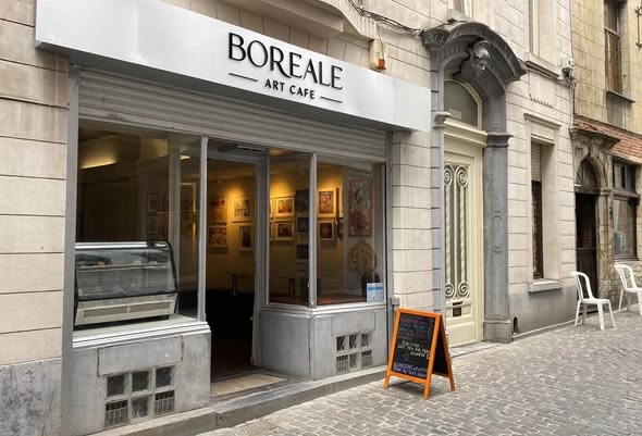 The Boréale Art Café storefront on a cobbled street with a chalkboard outside