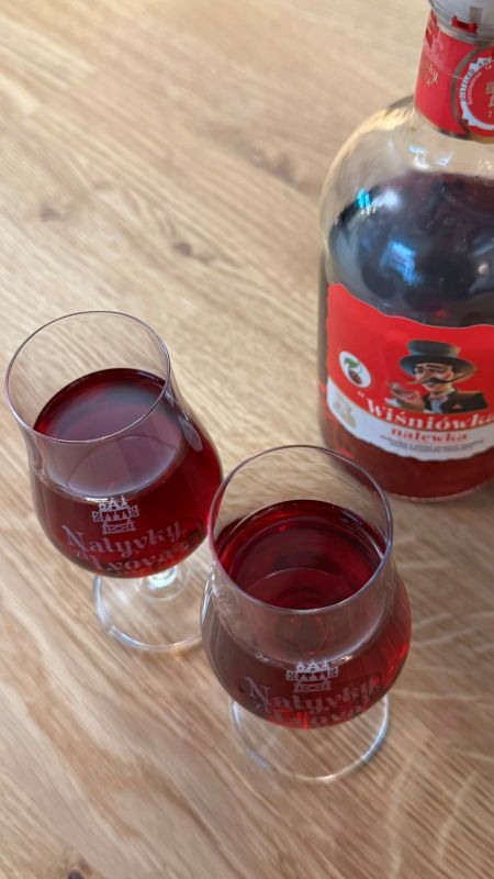 Two tulip glasses of dark red Wiśniówka seen from above